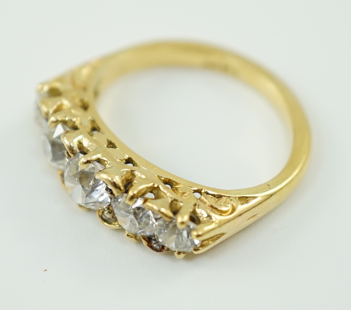 An 18ct gold and graduated five stone diamond set half hoop ring